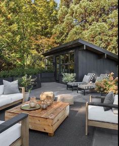 an outdoor living area with couches, tables and chairs in the middle of it