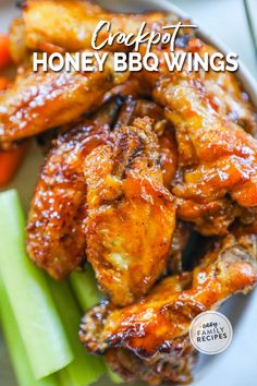 chicken wings with carrots and celery on a white plate that says copypot honey bbq wings