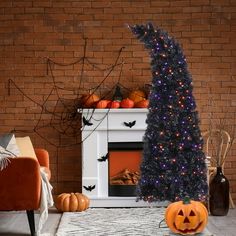 a decorated halloween tree in front of a fireplace