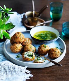 small appetizers on a plate with dipping sauce in a bowl next to it