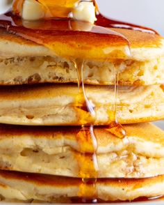 a stack of pancakes with syrup and butter on top