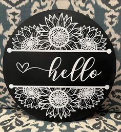 a black and white sign that says hello with sunflowers in the center on a leopard print background