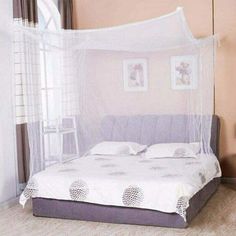 a bed with a white canopy over it