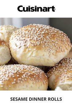 sesame dinner rolls are piled on top of each other