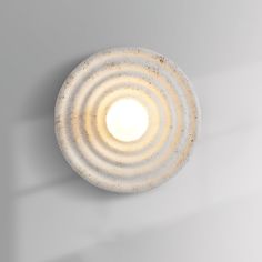 a light that is on the side of a wall in a room with white walls