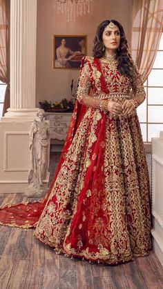 a woman in a red and gold bridal gown