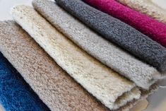 several different colored towels sitting on top of each other