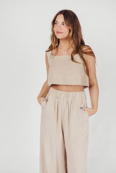 The Christy Top is the epitome of contemporary femininity. From its soft linen-blend fabric to its flattering neckline and cropped silhouette, this top offers premium-quality details. It's a stunning choice paired with the Samantha Maxi Skirt, or style it with white trousers or your favorite denim. Available in two colorways. FIT: Runs true to size. If you are a C-cup or larger, consider that this top is significantly cropped. MODEL: Model is 5’7” / wearing a small. MATERIAL: 55% Linen, 45% Rayon. GARMENT DETAILS: Premium quality linen-blend dressy tank. Features a square neckline, wide shoulder straps, and a cropped silhouette. SIZE GUIDE: XS (00-2) / S (2-4) / M (6-8) / L (10-12) Chic Linen Crop Top For Spring, Chic Cropped Linen Tops, Chic Beige Sleeveless Crop Top, Sleeveless Linen Crop Top For Summer, Chic Cropped Hem Crop Top For Summer, Chic Sleeveless Blouse Crop Top For Day Out, Chic Sleeveless Crop Top For Day Out, Sleeveless Linen Crop Top For Spring, Sleeveless Linen Crop Top For Vacation