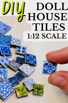 a hand holding a blue and white tile with the words diy doll house tiles 11 / 12 scale