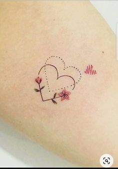 a small heart tattoo on the back of a woman's arm with flowers and arrows