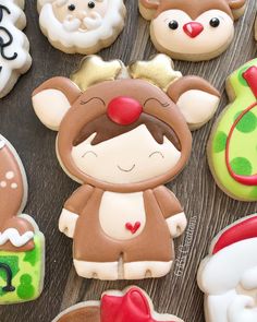 decorated cookies are arranged on a wooden table