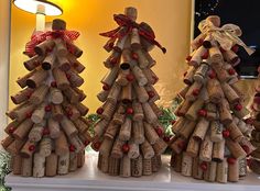 three wine cork christmas trees on a mantle