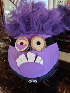 an odd looking purple object with eyes and hair