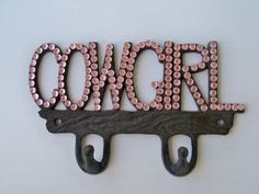 a metal sign that says once on it with some pink beads hanging from the hooks