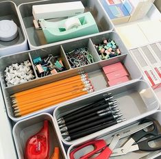 an organized drawer with scissors, pencils and other office supplies