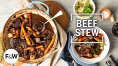 beef stew with carrots, mushrooms and parsley in a pot on a table