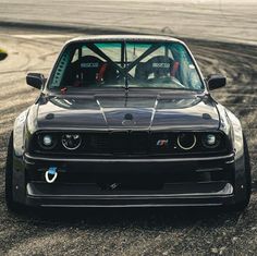 a black car parked on top of a race track