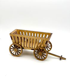 a wooden toy wagon with wheels and spokes on the front is shown against a white background