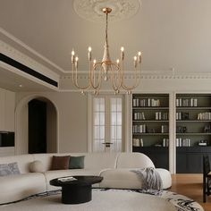 an elegant living room with white furniture and chandelier