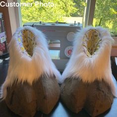 a pair of furry shoes sitting on top of a table