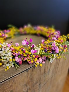 a bunch of flowers that are on top of a wooden box with some kind of decoration