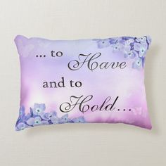 a purple pillow with blue flowers and the words to have and to hold on it