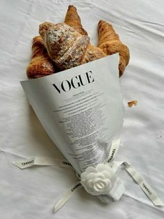 croissants wrapped in paper on top of a bed