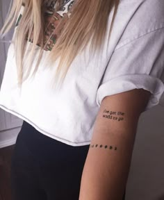 a woman with a tattoo on her arm saying i've got the road to go