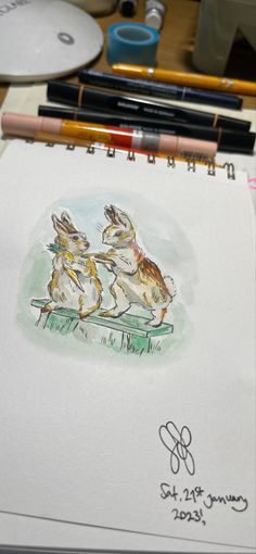 a drawing of two rabbits sitting on top of a table