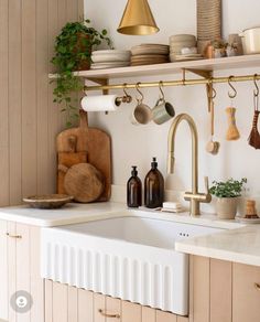 a kitchen with wooden cabinets and shelves filled with pots, pans, and utensils