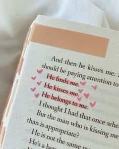 an open book with pink hearts on it and the words, and then he kisses me i should be paying attention to him