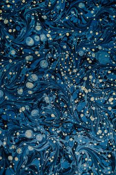 an abstract blue and gold painting with white dots