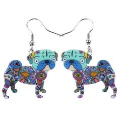 a pair of earrings with a dog painted on it's face and colorful designs