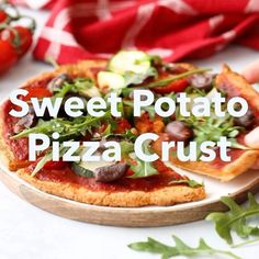 a person holding a piece of pizza with the words sweet potato pizza crust on it