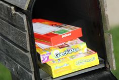 three boxes of candy sitting in an open mailbox