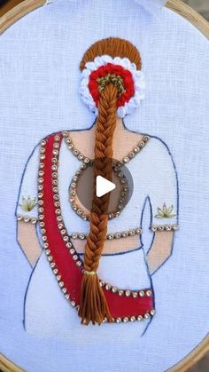 a woman with braids in her hair is shown on the embroidery hoop that has been stitched into it