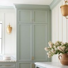 a vase filled with flowers sitting on top of a counter