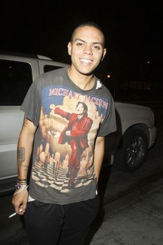 a man standing in front of a white truck at night wearing a michael jackson t - shirt