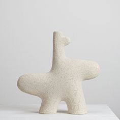 a white sculpture sitting on top of a table