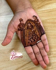 a person's hand with a hendi on it and an image of the virgin mary