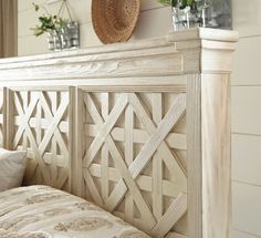 a white bed sitting next to a wooden headboard