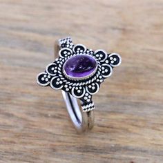 For a dreamy accessory to add to your wardrobe this cocktail ring is designed by Bali's Ketut Sulastri. She handcrafts the ring of sterling silver with an intricate crown that is centered by an oval cabochon of gleaming purple amethyst. Bohemian Silver Amethyst Ring, Bohemian Amethyst Crystal Ring In Silver, Silver Bohemian Amethyst Rings, Bohemian Amethyst Ring As Gift, Bohemian Amethyst Ring, Spiritual Sterling Silver Amethyst Ring, Bohemian Silver Amethyst Ring In Sterling Silver, Bohemian Sterling Silver Amethyst Ring With 925 Stamp, Intricate Amethyst Ring In Sterling Silver