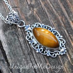 Handmade, Natural Tigers Eye Sterling Silver pendant on a 18" Sterling Silver Chain. ❤︎Featured in this listing is a sterling silver, handmade, natural stone pendant.  This lovely handmade pendant features a beautiful, Natural Tiger's Eye marquise shaped stone.  ❤︎The lovely marquise stone has been bezel set into a highly polished, victorian style embellished Sterling Silver setting, with with a large detailed bail.   ❤︎All made with Sterling Silver and comes featured on an 18" Chain  Main Stone Brown Hallmarked Jewelry As Gift, Hallmarked Brown Jewelry As Gift, Brown Hallmarked Jewelry Gift, Elegant Brown Jewelry Stamped 925, Sterling Silver Brown Necklace For Gift, Elegant Brown Stamped 925 Jewelry, Elegant Brown 925 Sterling Silver Jewelry, Handmade Brown Sterling Silver Necklace, Vintage Brown Jewelry Stamped 925