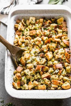 a casserole dish filled with stuffing and vegetables