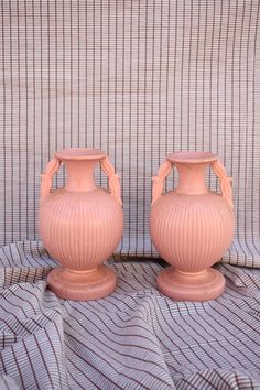 Rare pair of Vintage 1960's Peach Pink Ceramic Vessels. Made in USA, Haeger Co. Good vintage condition, only notable flaws include small markings of discoloration in a few small areas, shown in last photo.  Dimensions: W 4.5" H 8" Pottery Urn, Haeger Pottery, Ceramic Vessels, Urn Vase, Photo Dimensions, Pink Ceramic, Ceramic Vessel, Peach Pink, Vintage 1960s