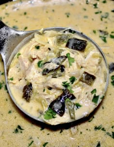 a spoon full of food sitting on top of a table