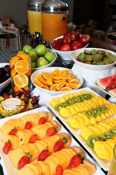 a table topped with lots of different types of fruits and veggie trays