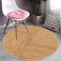 a white chair sitting on top of a wooden floor next to a potted plant