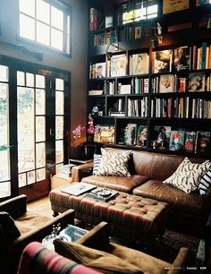 a living room filled with furniture and lots of books