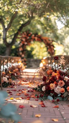 an outdoor ceremony with flowers on the ground